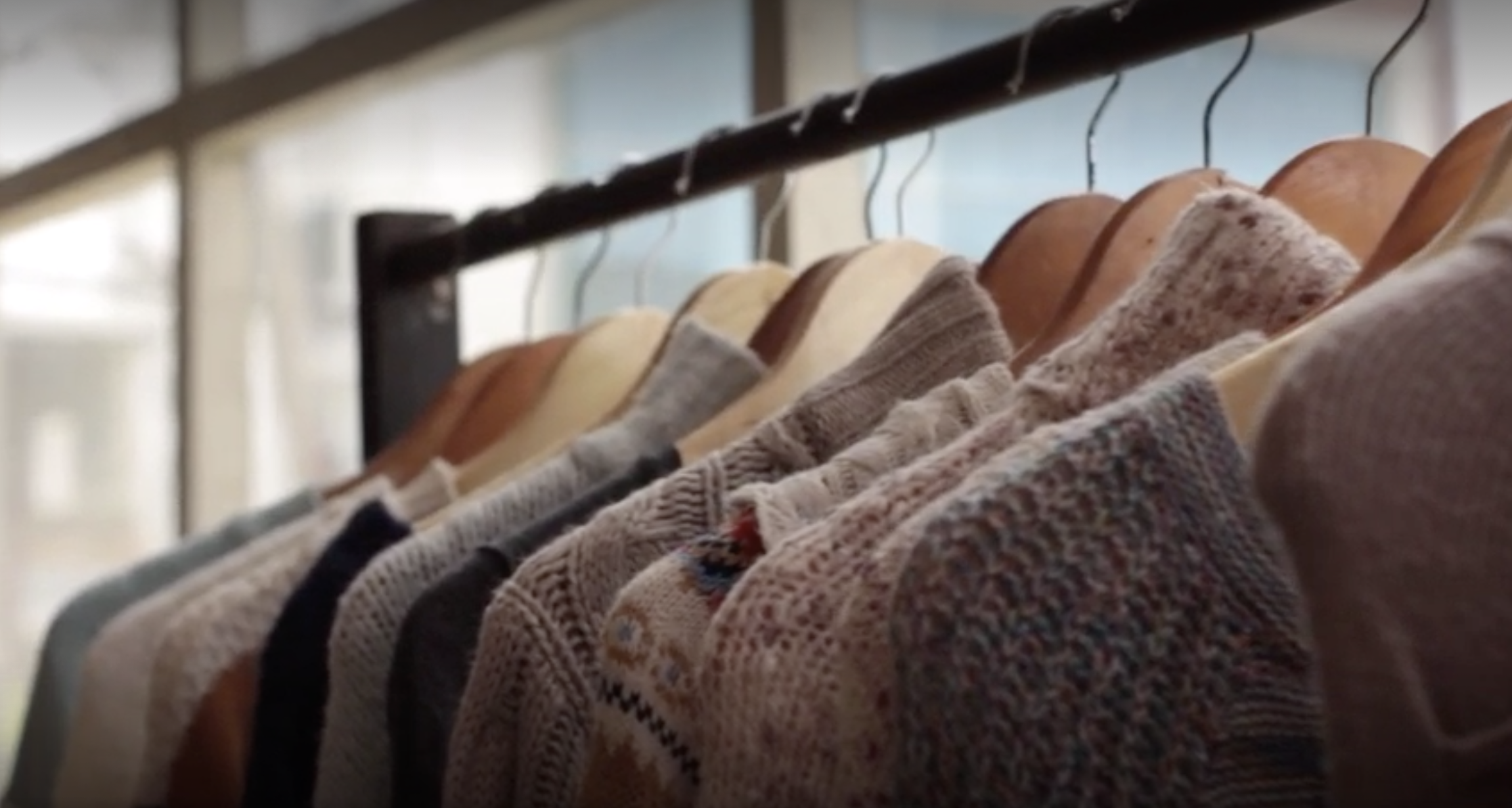 High fashion garments from upcycled yarn hanging on a rail